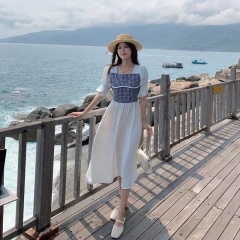 Seaside resort style small fresh white dress summer 2022 horn sleeve stitched Plaid fake two-piece medium and long skirt