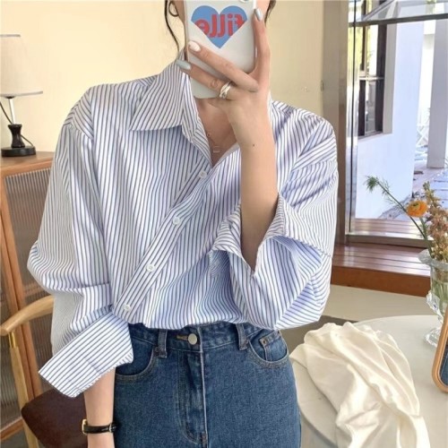 In the early spring of , the new Korean style retro design sense fashion niche irregular oblique button striped long-sleeved shirt