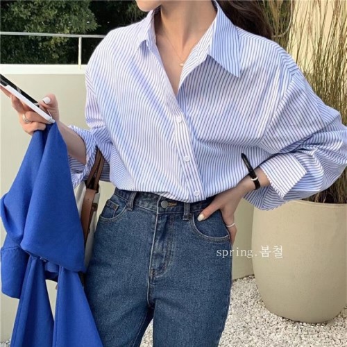 In the early spring of , the new Korean style retro design sense fashion niche irregular oblique button striped long-sleeved shirt