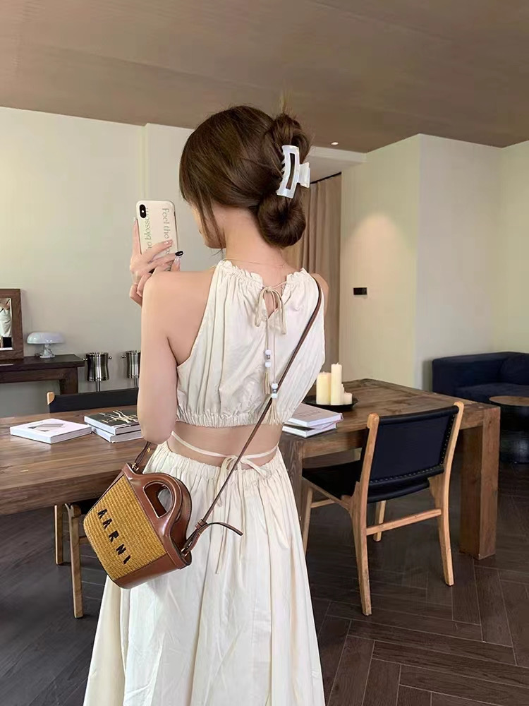 Design sense hollow waist hanging neck suspender dress women's summer tie waist slimming holiday style tassel mid-length skirt