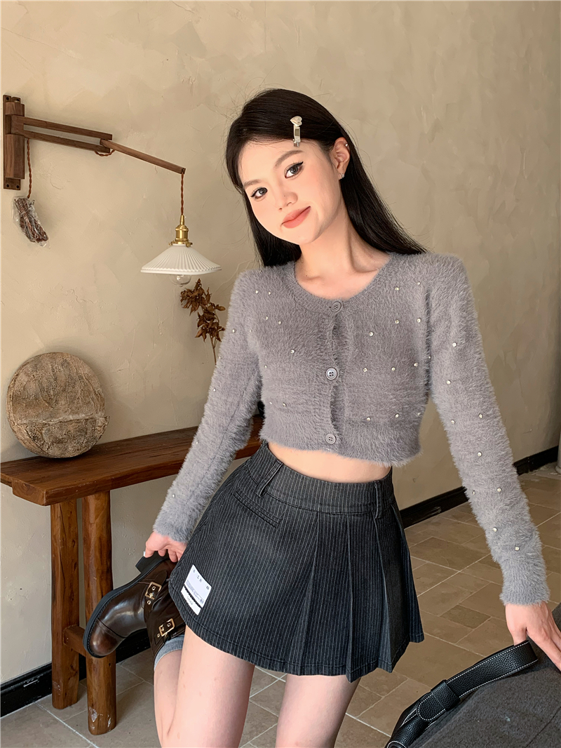 Actual shot of plush knitted sweater with buttons and diamond cardigan top