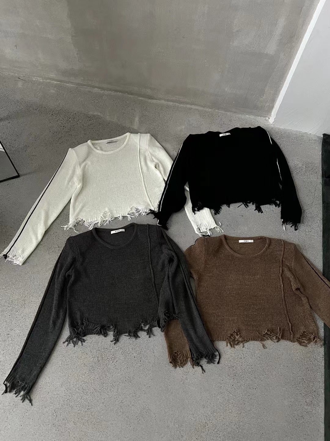 Thirteen lines of Korean style autumn design ripped tassel long-sleeved round neck sweater for women fashionable simple knitted sweater top