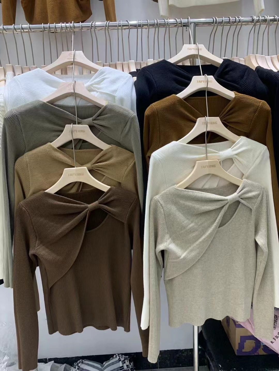 2023 new autumn design hollow irregular bow long-sleeved sweater solid color slimming top for women