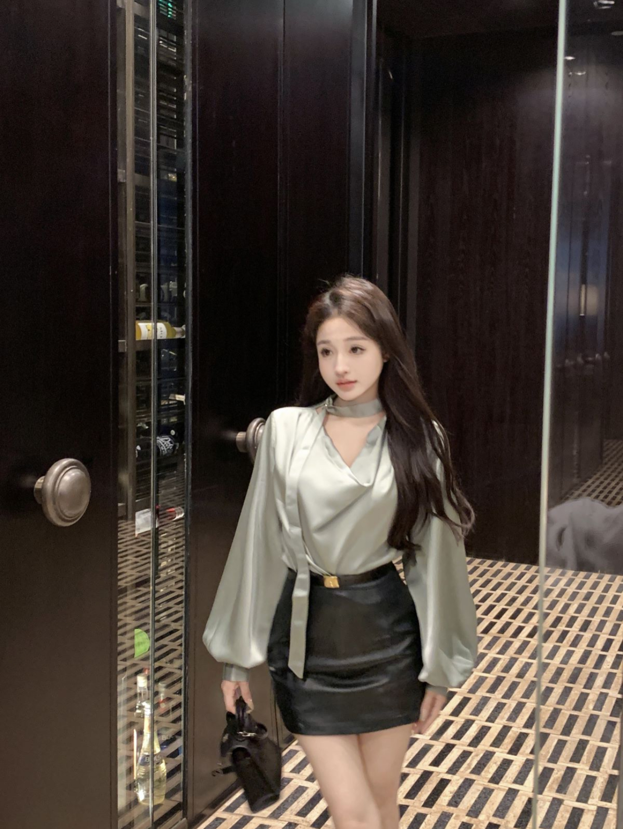 Real shot of high-end pea green satin shirt and dark green leather skirt two-piece suit