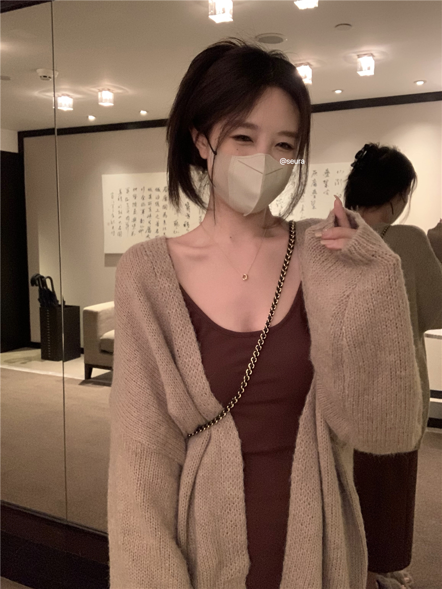 Actual shot of a relaxed and lazy hanging slim mohair loose cardigan wool sweater jacket with a suspender skirt suit inside