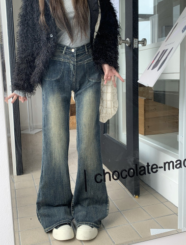 Actual shot of high-waisted slimming retro distressed stretchy bootcut floor-length jeans