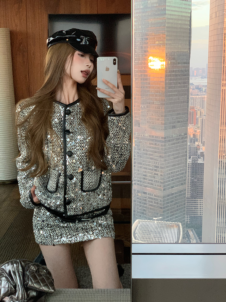 Actual shot of silver sequins decorated small fragrant black leather-trimmed collarless jacket low-waisted skirt suit