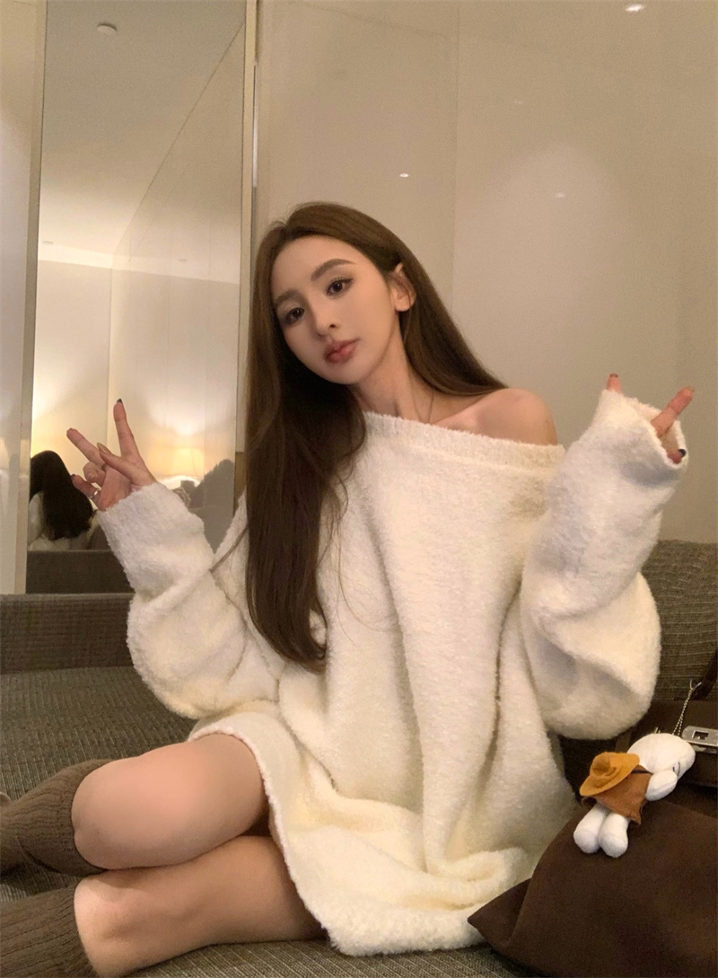 Actual shot of retro style lazy and loose white knitted mid-length sweater