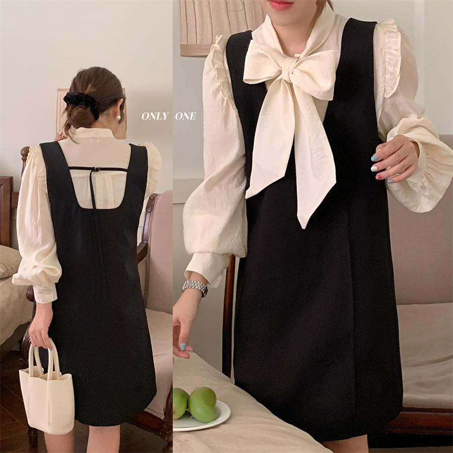 Actual shot of a playful, loose-fitting shirt with a big bow collar and a simple and versatile suspender skirt suit