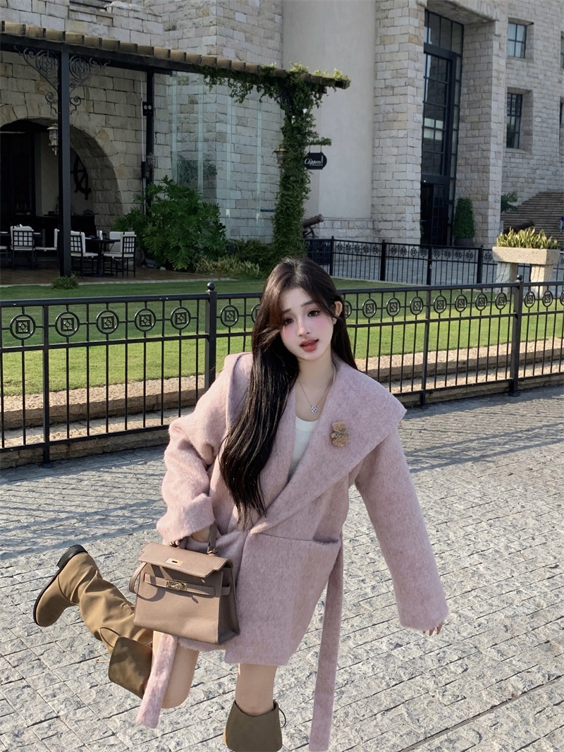 Actual shot with soft light filter. Beautiful matte pink wool long plush hooded coat for women.