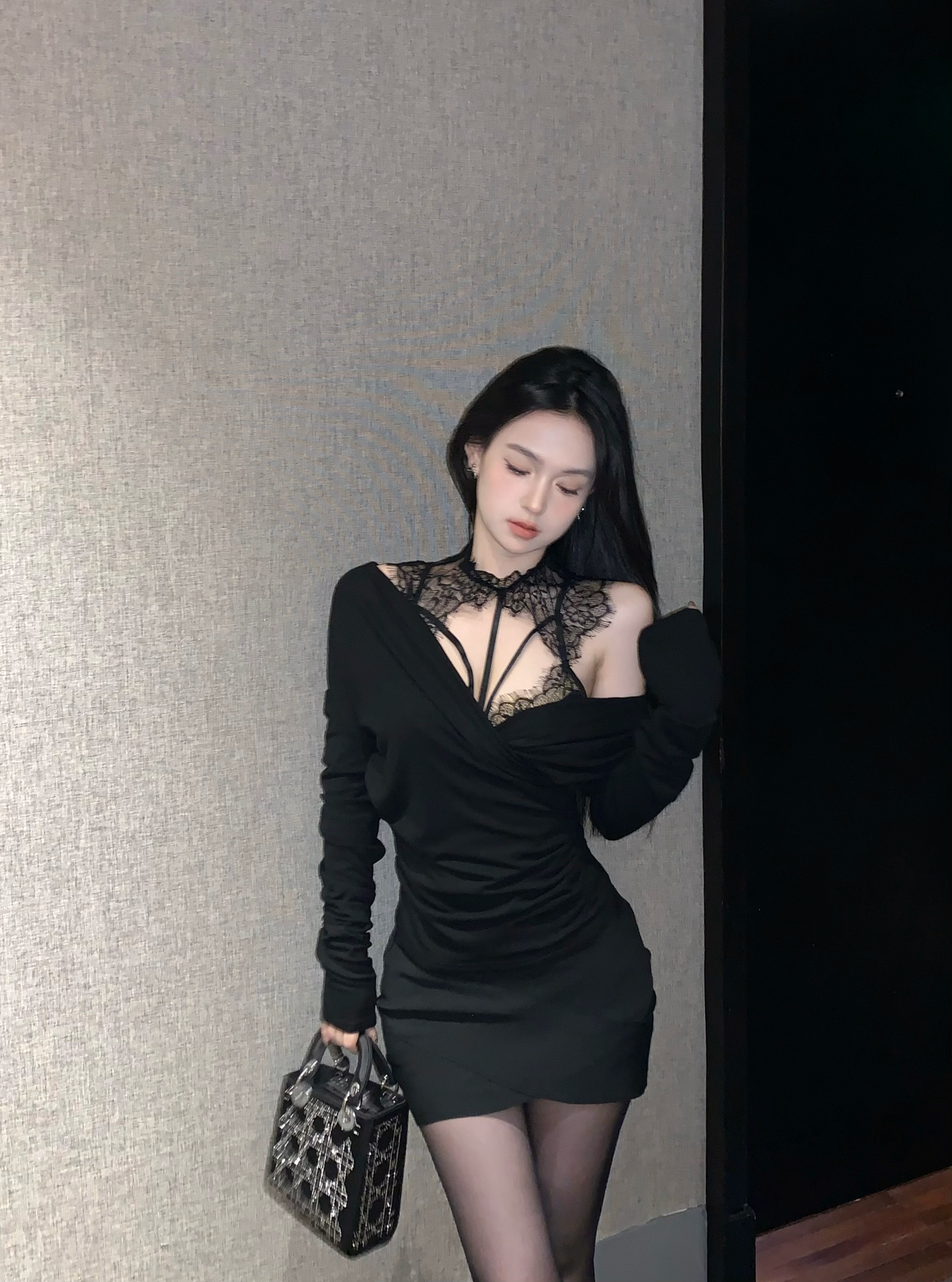 Real shot of a sexy woman wearing a lace top with suspenders and one shoulder long sleeve two-piece suit
