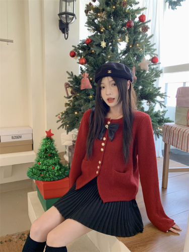 Actual shot of a fashionable two-piece Christmas-style bow-tie sweater and woolen high-waisted pleated skirt