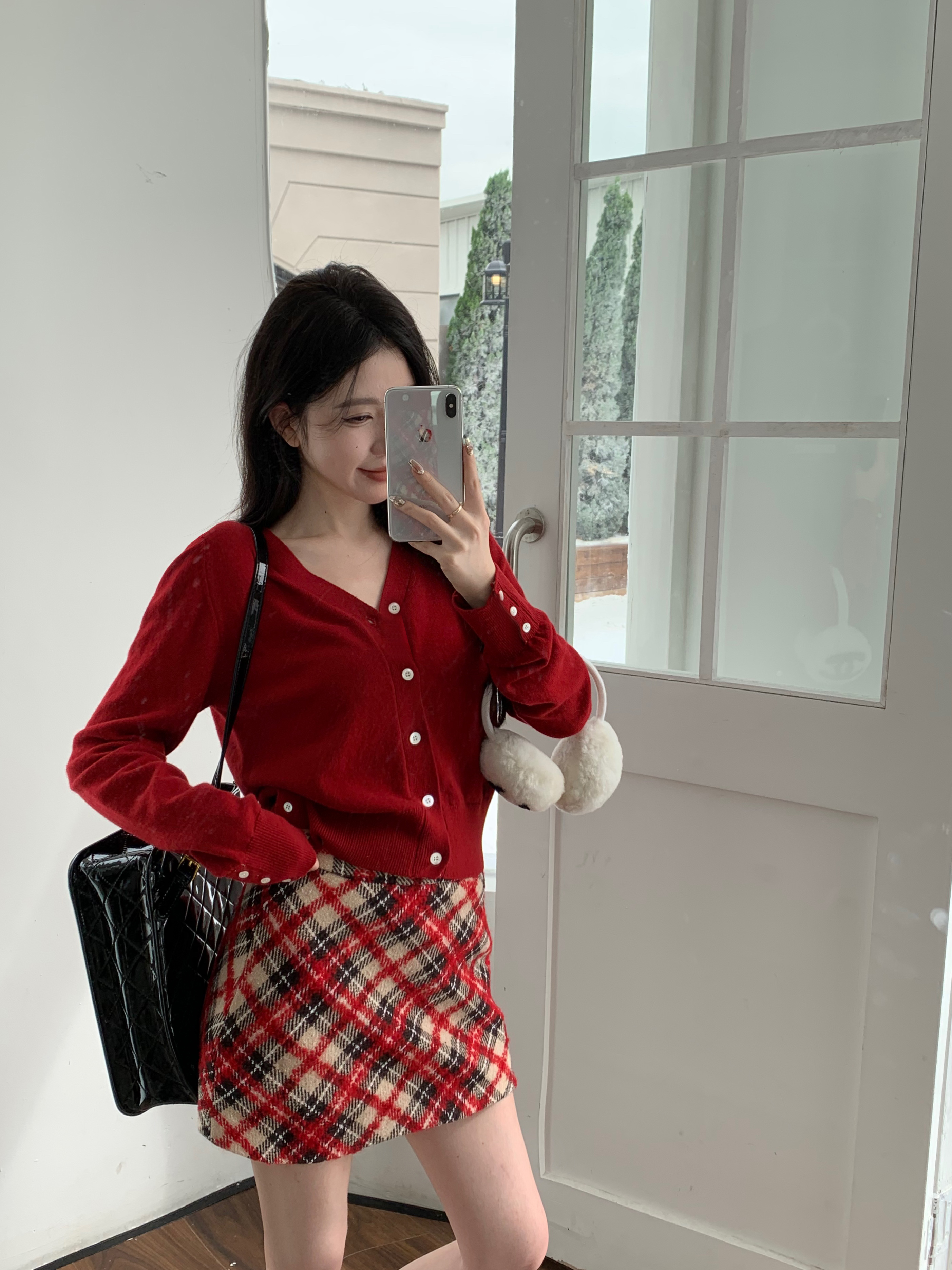 Actual shot of a girl's old-money style long-sleeved sweater with cardigan top and plaid skirt two-piece set