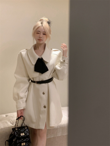 Real shot of woolen cape and windbreaker coat for small people in autumn and winter. White woolen coat with waistband