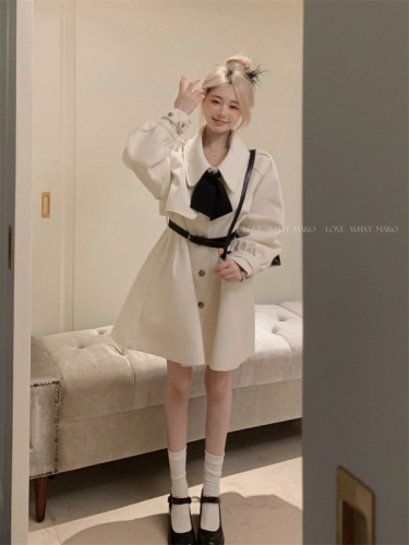 Real shot of woolen cape and windbreaker coat for small people in autumn and winter. White woolen coat with waistband