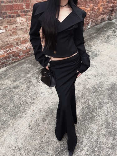 Real shot of urban women's waist-cinching suit, shoulder-padded top, slimming low-waisted fishtail skirt suit