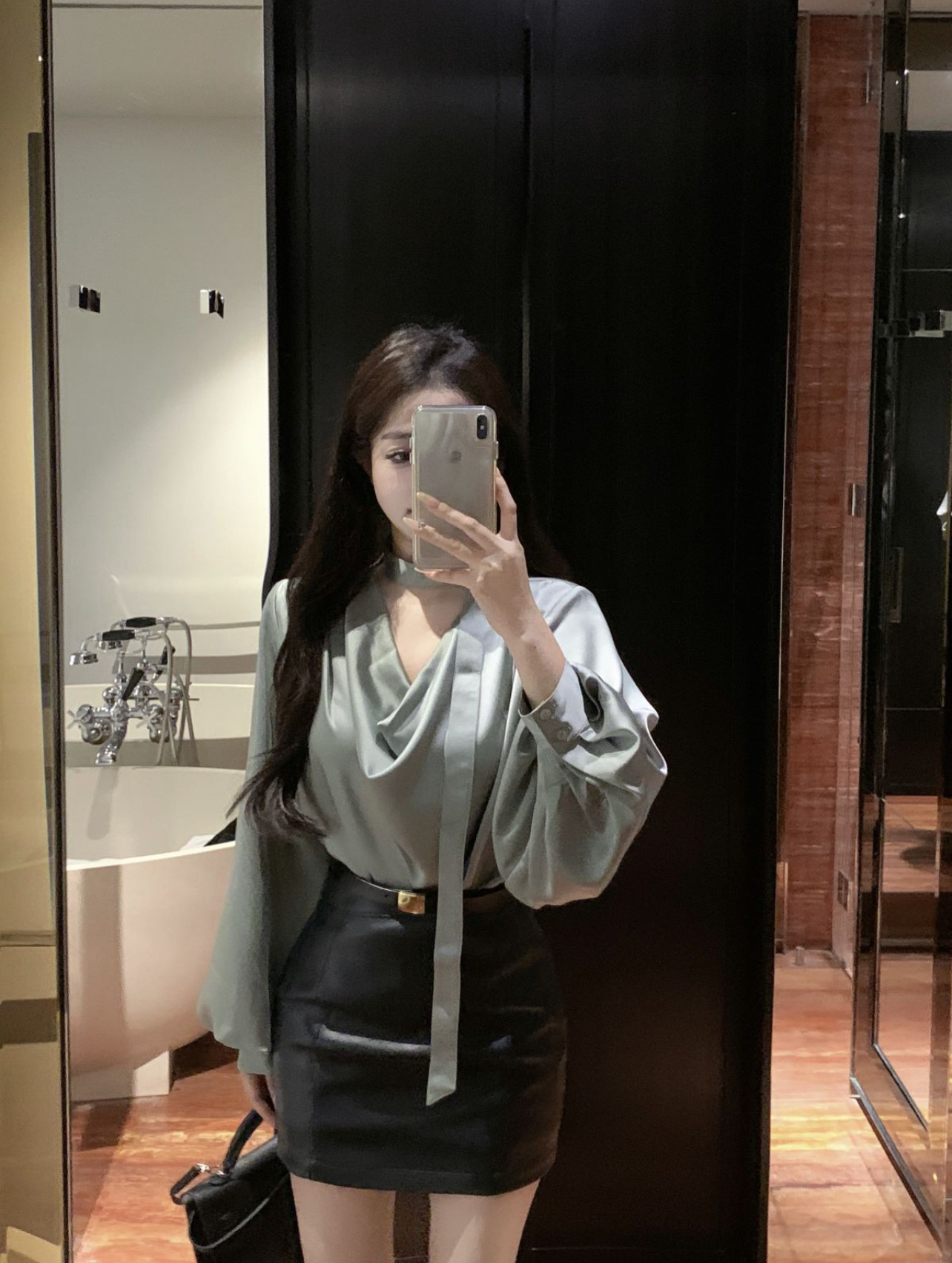 Real shot of high-end pea green satin shirt and dark green leather skirt two-piece suit