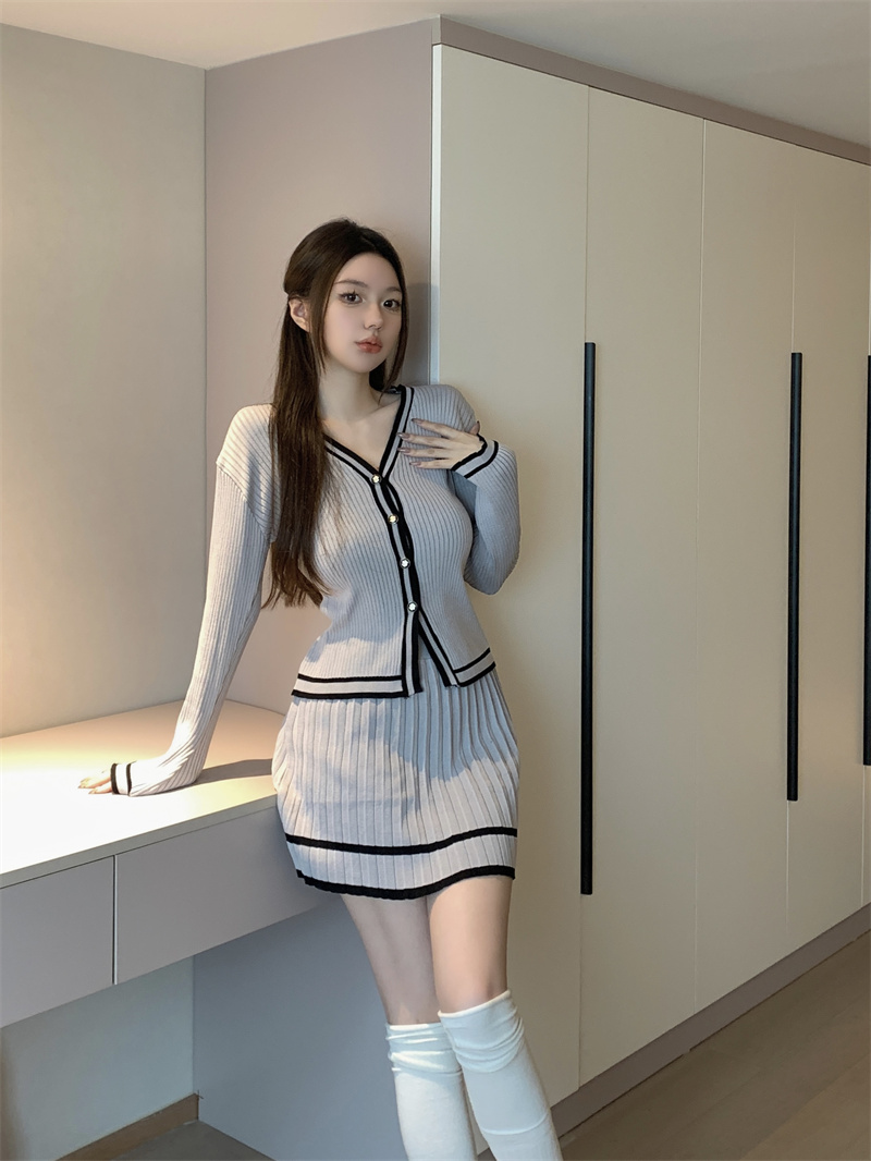 Actual shot of a slim and elegant waist-cinching button-down long-sleeved top and short skirt knitted suit