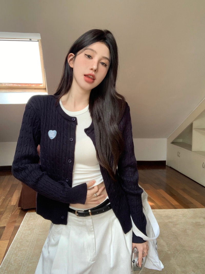 Real shot of navy blue twist knitted cardigan, white racer vest, white drapey slimming wide-leg pants suit