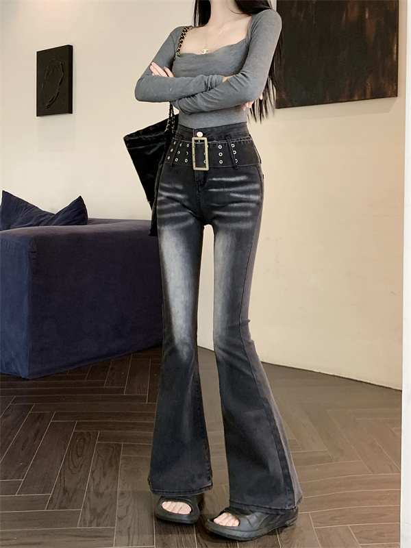Actual shot of designer retro high-waist slim washed micro-flare stretch jeans with belt