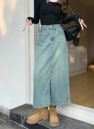 Actual shot#High-waisted front slit denim half-length skirt for women. Washed design with back pockets and holes. A-line mid-length skirt.