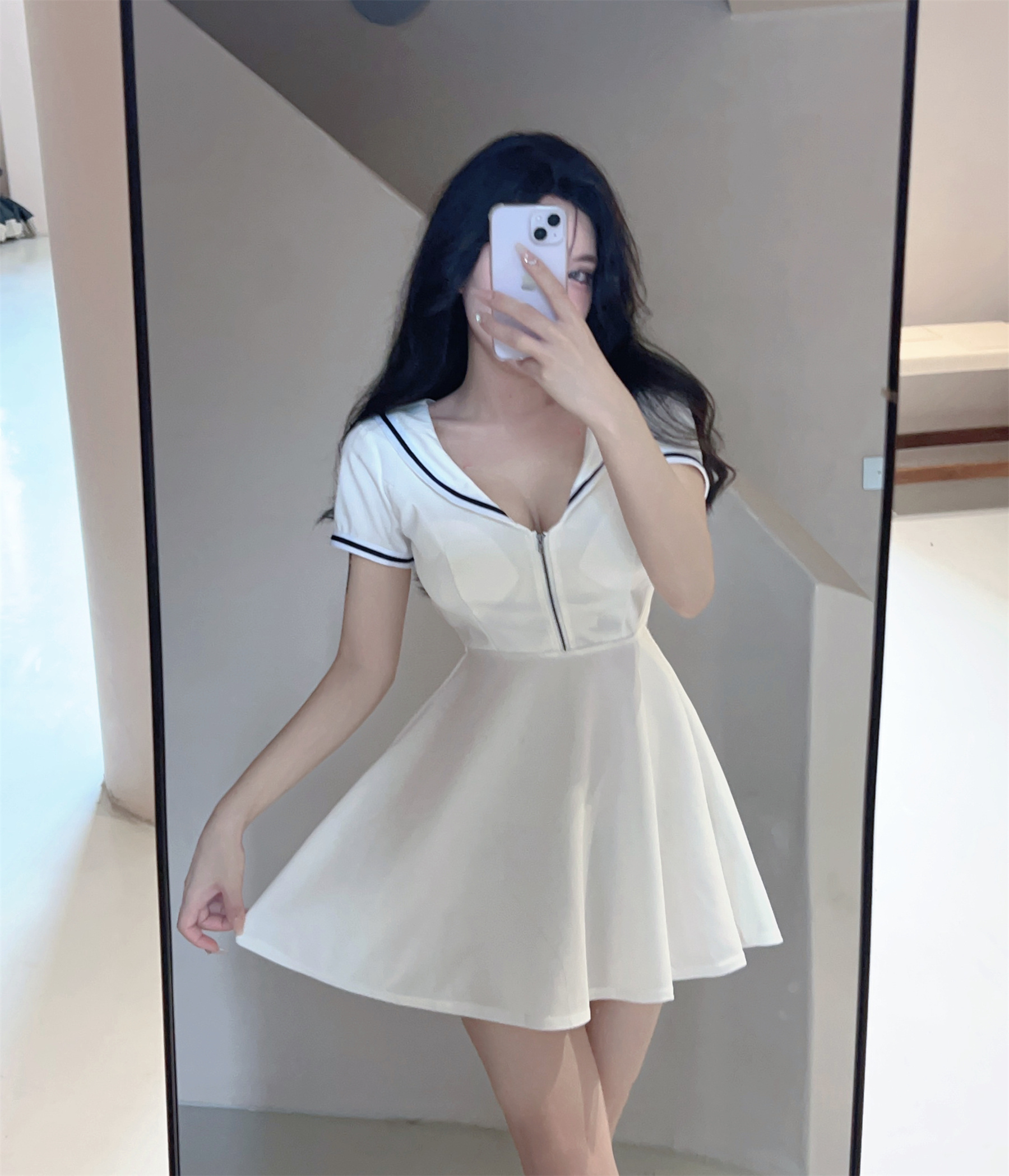 A real-life photo of a celebrity wearing a navy neckline waist up dress in contrasting colors, featuring a female Xia's niche design and elegant skirt