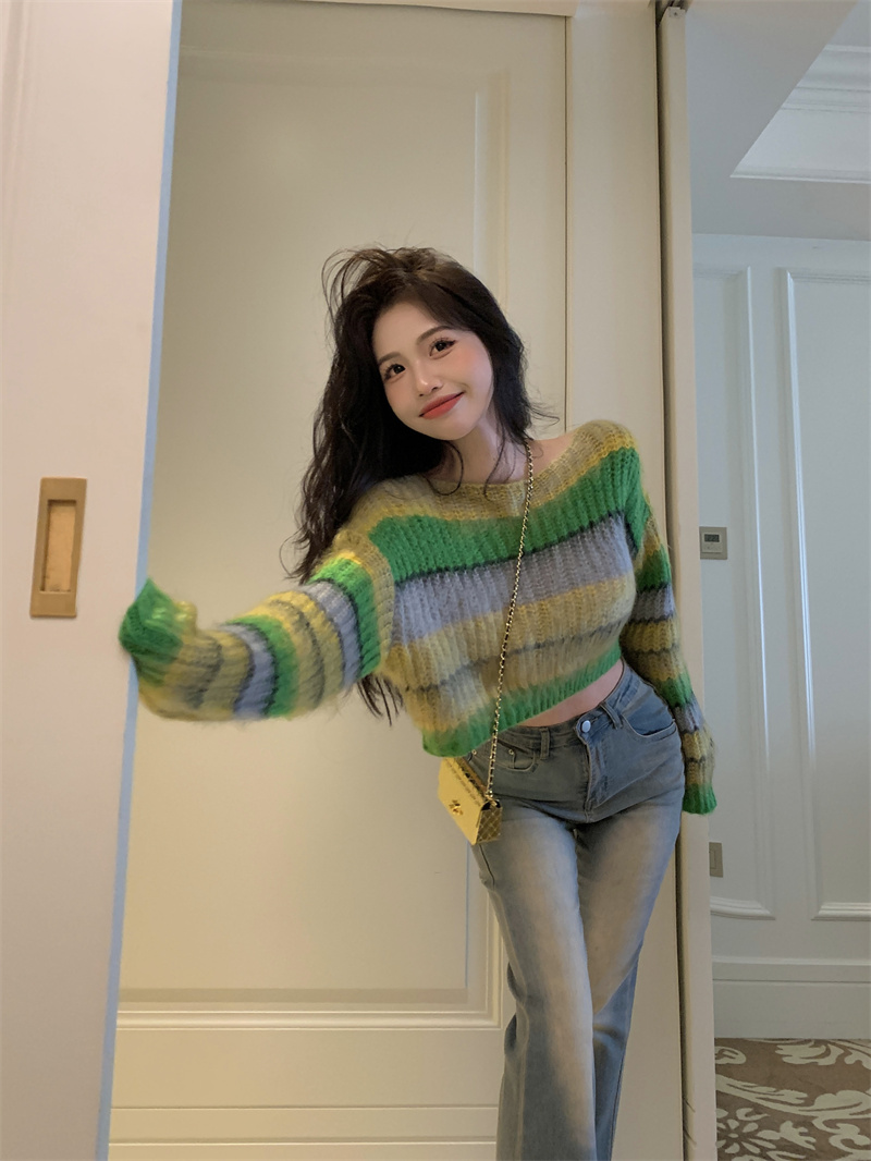 Real shot of a hot girl with a gentle and lazy design in contrasting striped pullover mohair short knitted sweater top