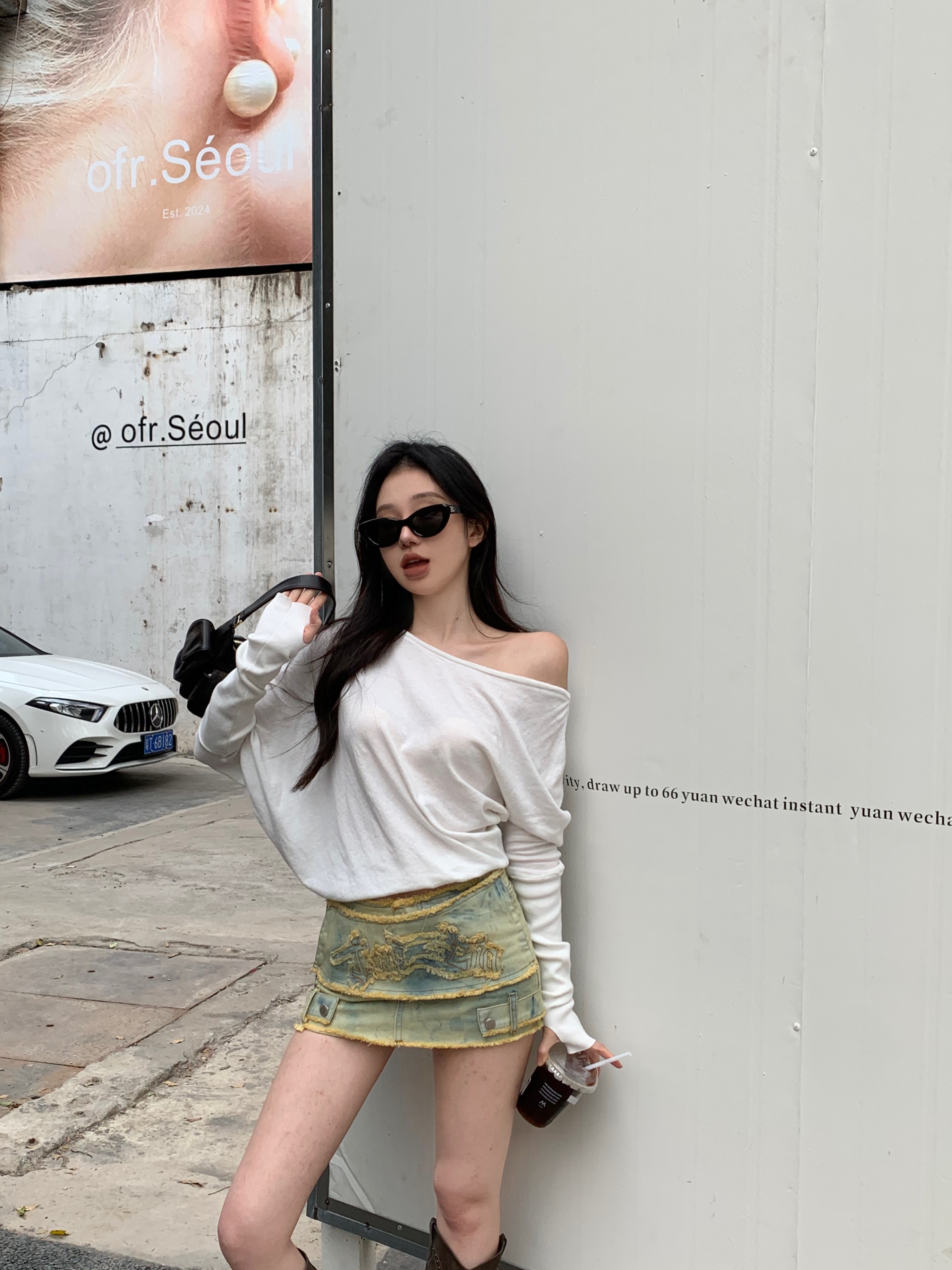 Actual shot of a spring off-shoulder white top with long sleeves and a T-shirt worn inside