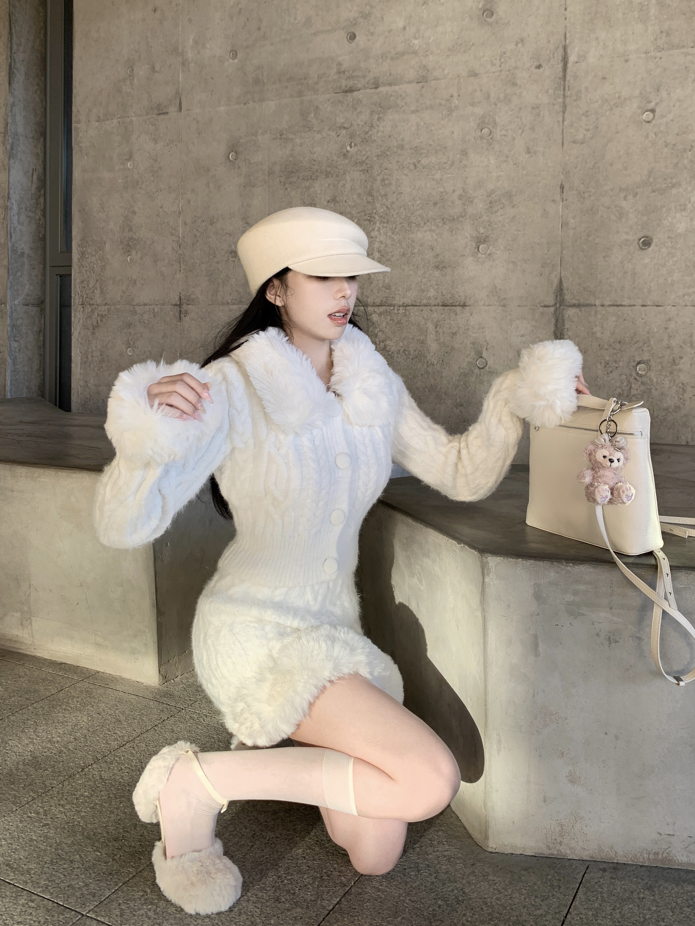 Real shot of white knitted suit, sweater suit, skirt two-piece set