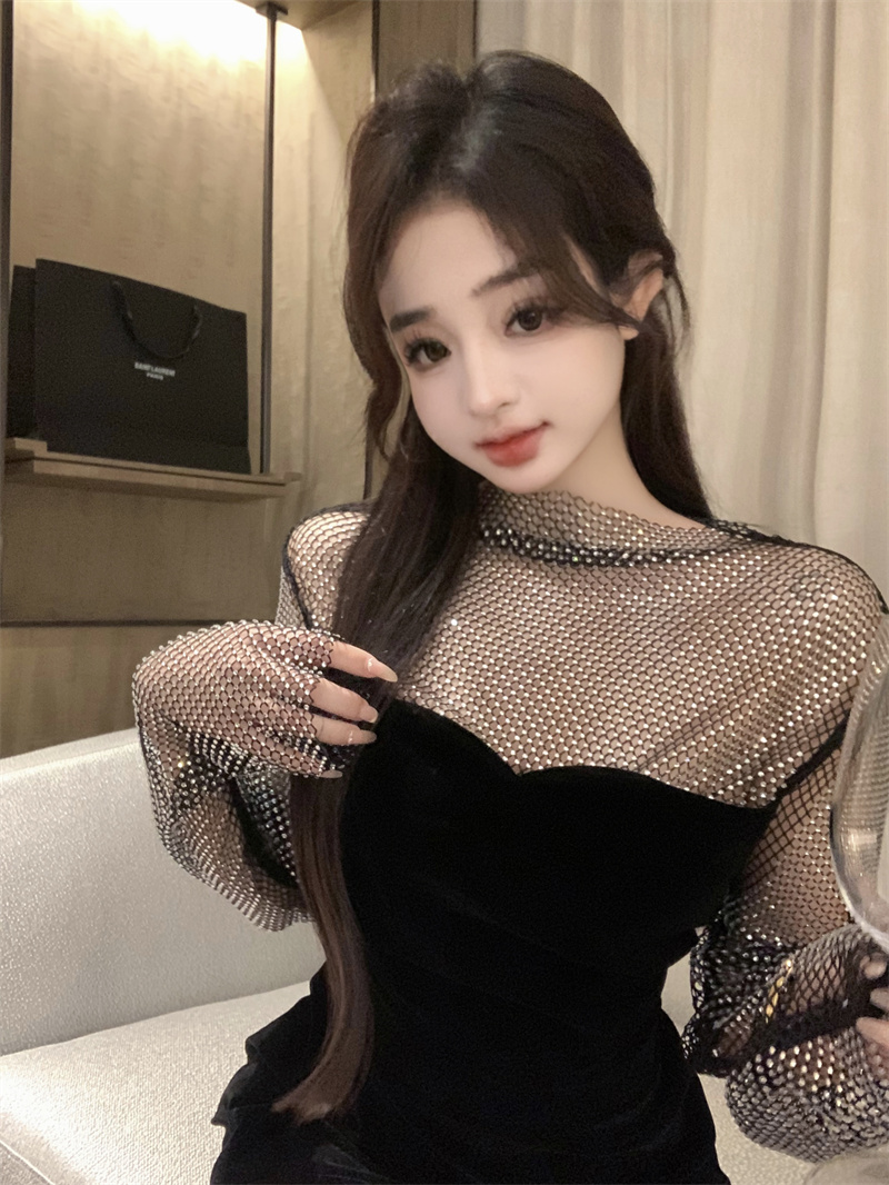 Actual shot of a dazzling black dress with diamonds that looks slimming