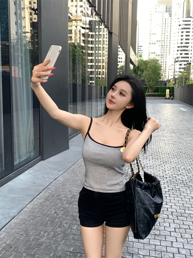 Real shot of gray striped camisole for women on summer seaside vacation, sexy hottie with beautiful back and inner top