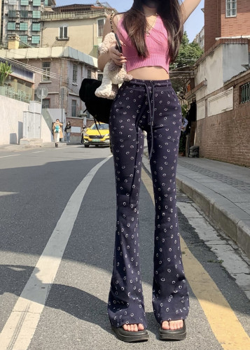 Real shot of extremely comfortable blue smiley face pants with slightly flared floor-length trousers for women with high waist and long legs and elastic waist
