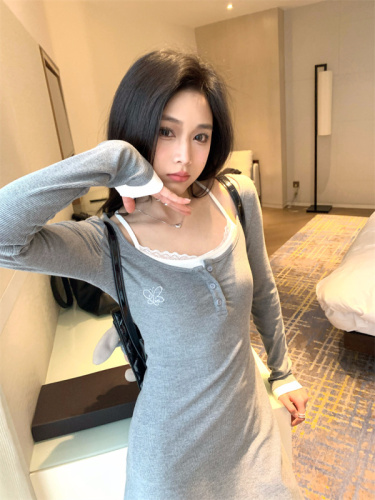 Real shot of a hot girl looking slim and waist-cinching in a two-piece gray long-sleeved dress