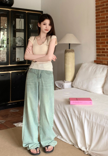 Real shot of retro nostalgic washed light-colored denim straight floor-length trousers for women