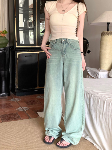 Real shot of retro nostalgic washed light-colored denim straight floor-length trousers for women