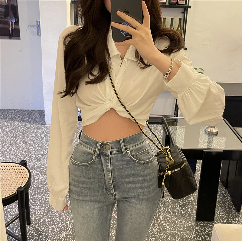Actual shot of a French-style niche design, a short shirt top with a bow tie at the back and exposed navel.