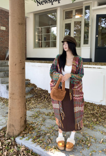 Actual shot of early spring warm ethnic style shawl blanket worn with a knitted cardigan cloak
