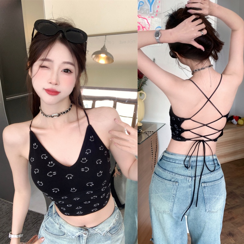 Real shot of a hot girl with a smiling face and a small camisole with a cross and backless strap design