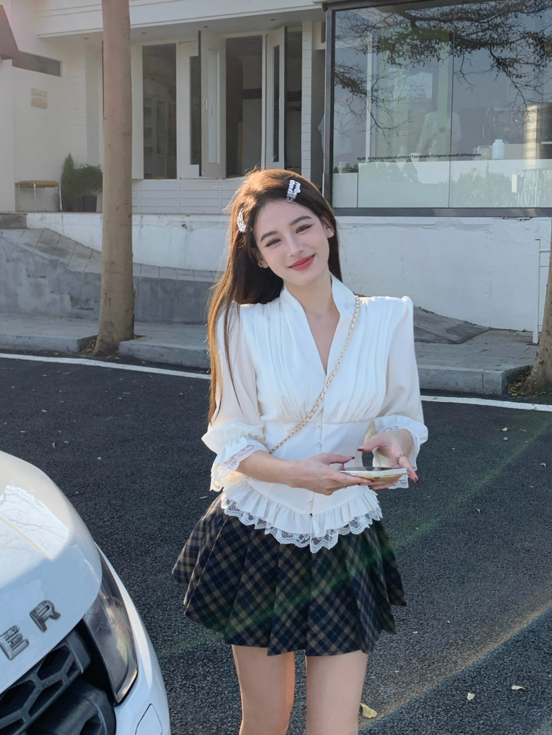 Real shot of white three-quarter sleeve lace ruffle shirt + plaid pleated skirt