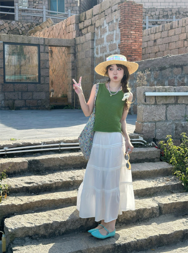 Real shot of simple textured knitted vest, white green sleeveless top, white high-waisted skirt suit