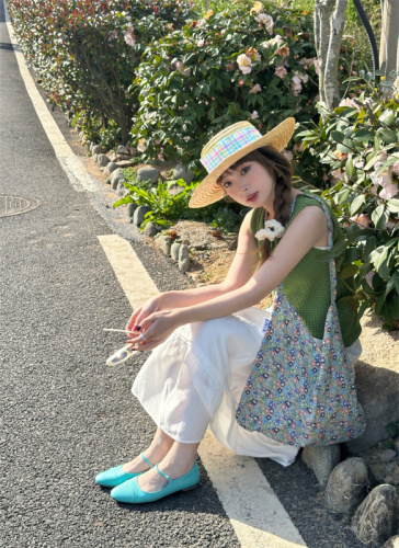 Real shot of simple textured knitted vest, white green sleeveless top, white high-waisted skirt suit