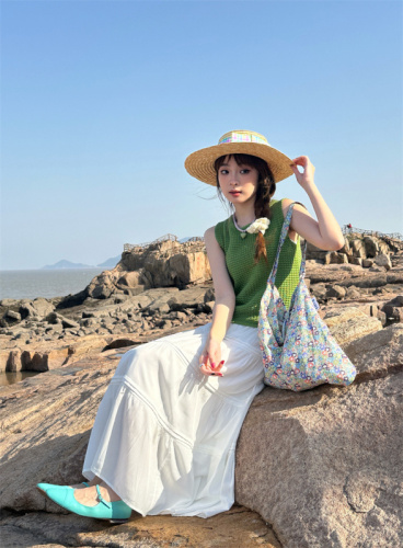 Real shot of simple textured knitted vest, white green sleeveless top, white high-waisted skirt suit