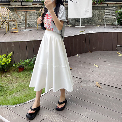 Actual shot of white skirt for women with high waist and drapey A-line mid-length skirt with elastic waist at the back and big strike skirt and umbrella skirt.