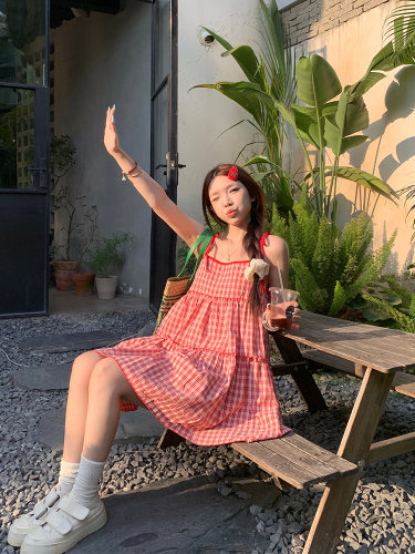 Real shot of Korean chic Xia's age-reducing person wearing a red plaid suspender dress