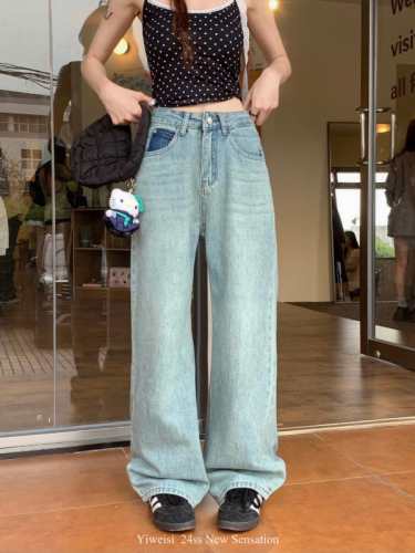 Actual shot of early spring loose wide-leg washed blue straight floor-length denim trousers