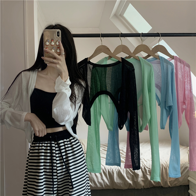 Real shot of summer short knitted cardigan worn over long-sleeved sun protection top for women