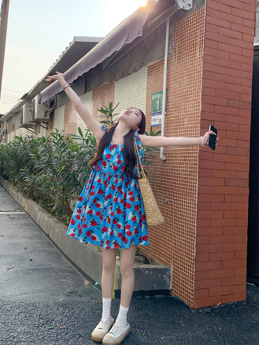 Real shot of Korean chic Xia wearing a rose blue strappy suspender skirt