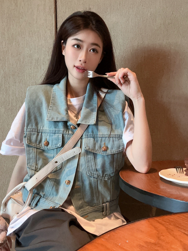 Real shot of a small fragrant style denim jacket with a summer design and a waistcoat with a sleeveless vest and a short top