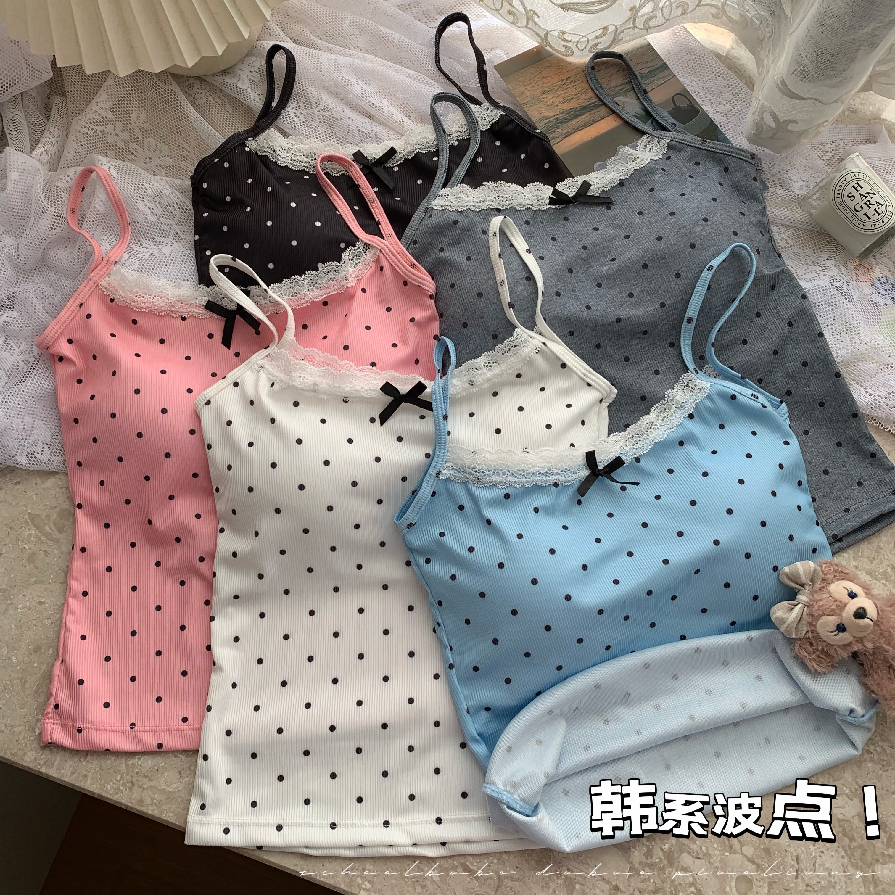 Real shot of a sweet hot girl wearing a blue lace camisole with polka dots and a short bottoming top with breast pads