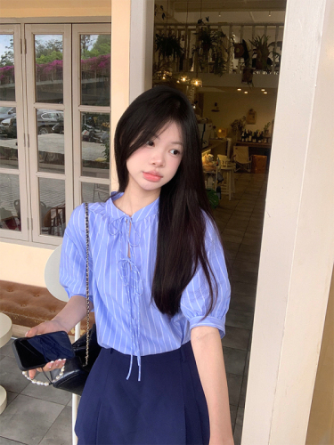 Actual shot of Korean chic Xia wearing a simple blue striped shirt and doll sweater